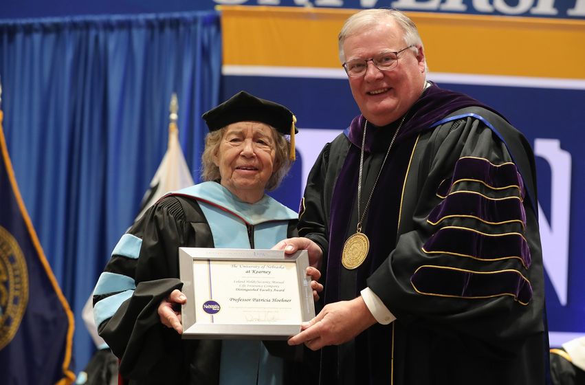 UNK Chancellor Doug Kristensen presents the Leland Holdt/Security Mutual Life Distinguished Faculty Award to professor Patricia Hoehner during Friday’s winter commencement ceremony at the Health and Sports Center on campus. (Photos by Erika Pritchard, UNK