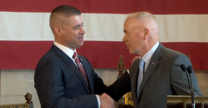 Chief Bryan Waugh (left) shakes hands with Col. John Bolduc