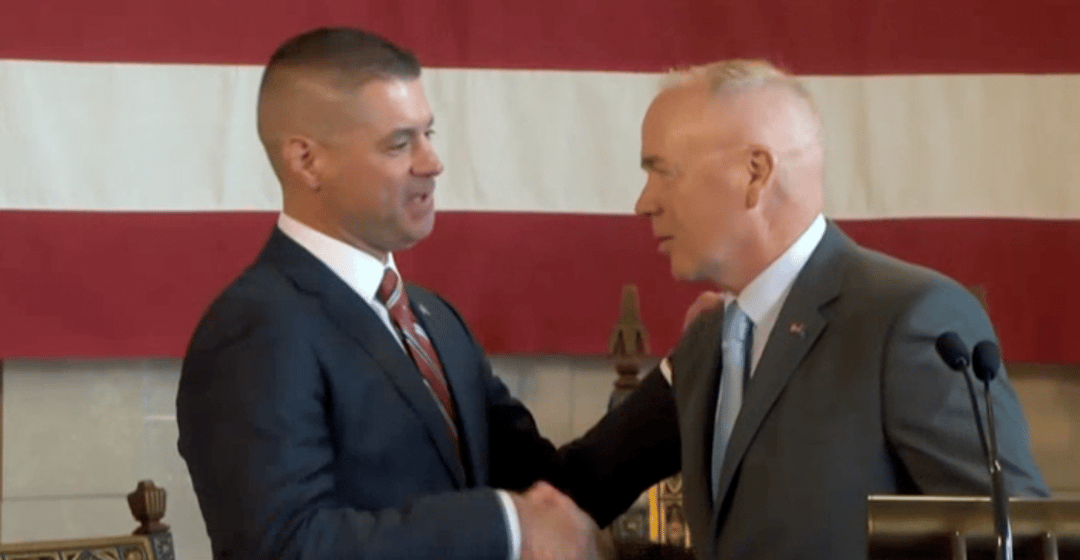 Chief Bryan Waugh (left) shakes hands with Col. John Bolduc