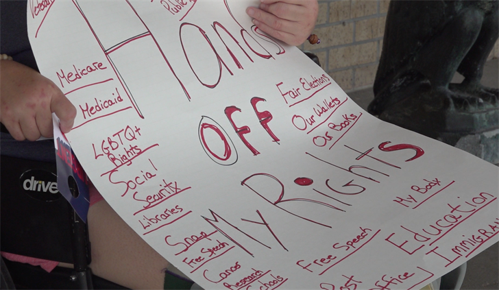 Protestors gather at Senator Pete Ricketts’ Kearney office