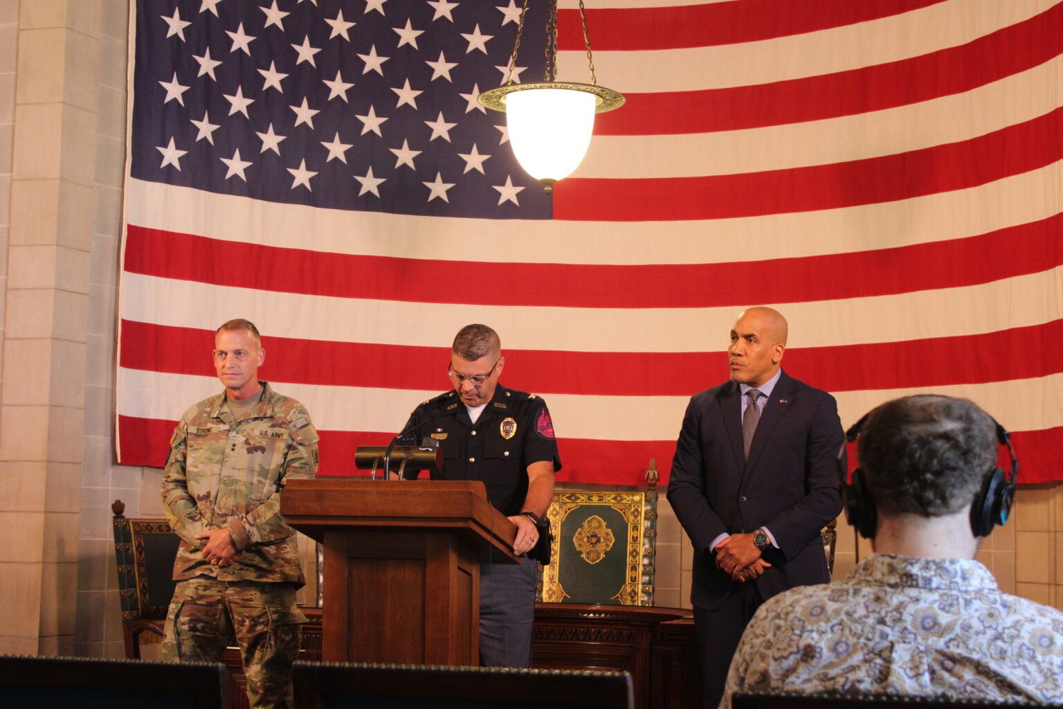 Nebraska State Patrol Superintendent Bryan Waugh, at podium, joins Nebraska Adj. Gen. Craig Strong at left and Nebraska Department of Correctional Services Director Rob Jeffreys as the state announces a new ICE facility. Aug 19. 2025.